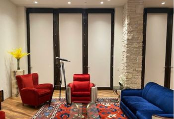 Spacious Calabasas living room featuring custom Somfy motorized shades providing a modern aesthetic.
