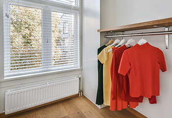 El Segundo closet with bright wardrobe and aluminum window blinds