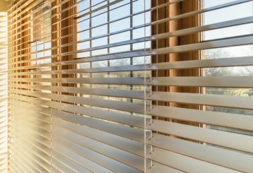 Faux wood blinds installed in a cozy bedroom