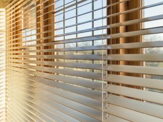 Faux wood blinds installed in a cozy bedroom