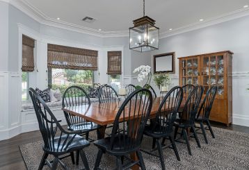 Enhance your kitchen with the rustic charm of woven wooden Roman shades, creating a cozy and inviting atmosphere.